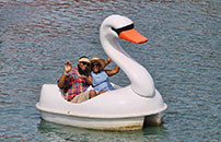 Couple relaxing on the swan boat as they float around lake Broadway